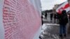 Belarus - The Belarusian flag by Marya Gryts with the names of political prisoners (1996-2022) at a rally in Kyiv.