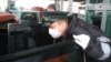 Poland -- Polish border guard wears protective gloves and mask as prevention against the swine flu on his duty at the Polish-Ukrainian border in Dorohusk, 04Nov2009