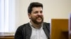 RUSSIA -- Leonid Volkov, a leading associate of Russian opposition leader Aleksei Navalny, smiles in a court room during a hearing in Moscow, March 31, 2017